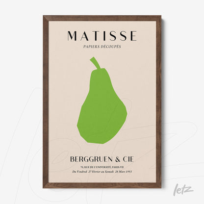 framed contemporary art print of a green pear on beige background with dark wood frame