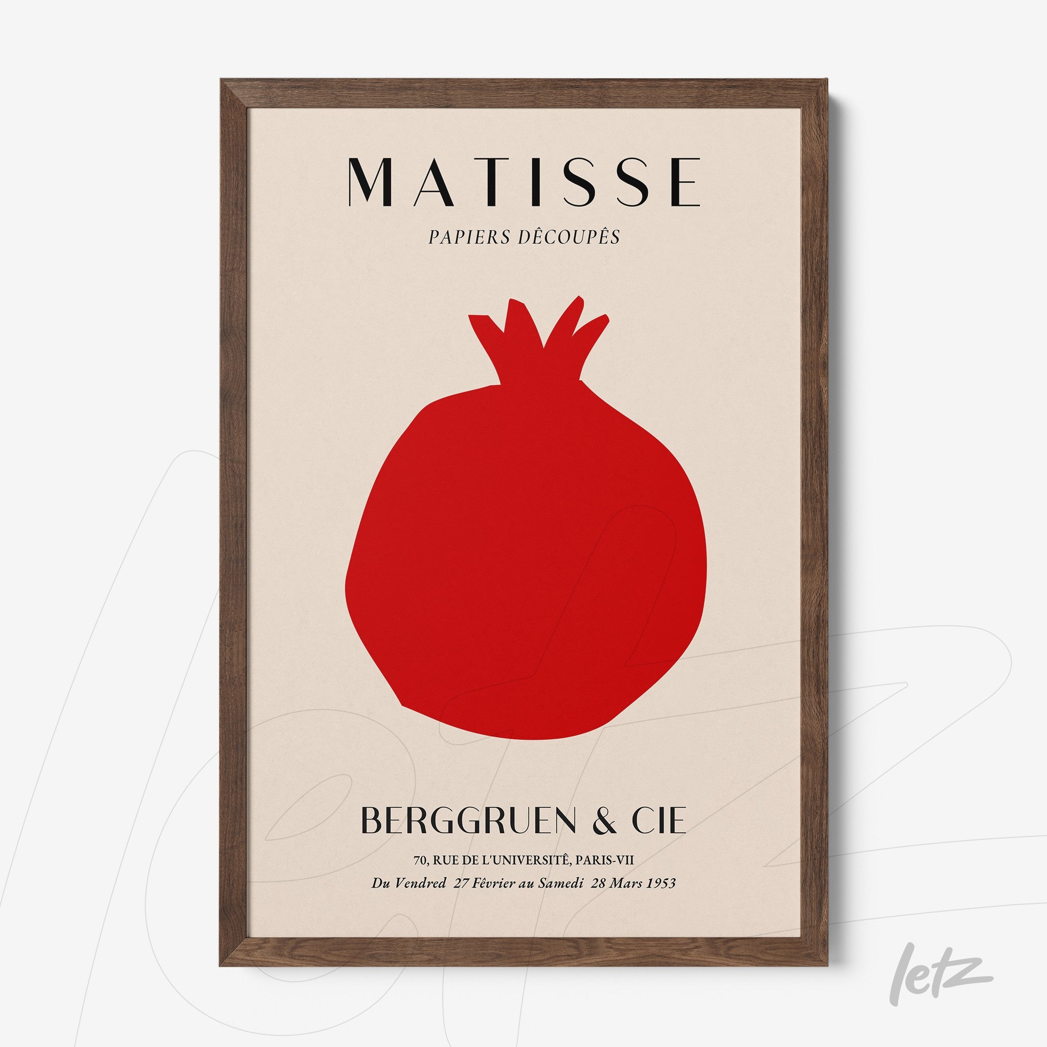 framed wall art featuring a minimalist design of a pomegranate in a light background with a dark wood frame