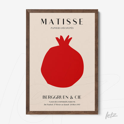 framed wall art featuring a minimalist design of a pomegranate in a light background with a dark wood frame
