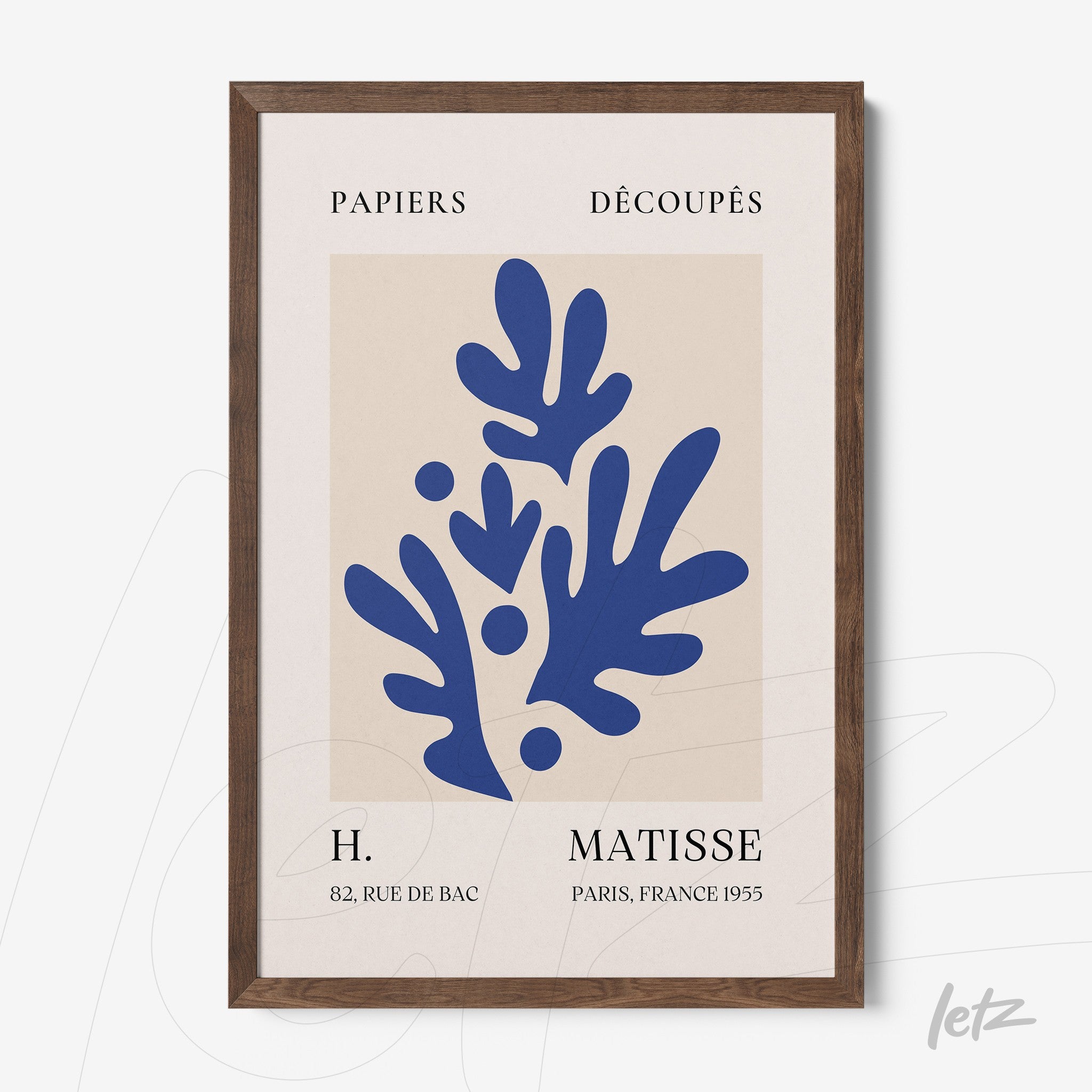 decorative wall art featuring modern blue cut-out shapes on a white background, framed in dark wood with text referencing the artist Matisse