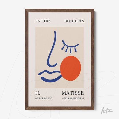 framed wall art featuring abstract stylized face design in blue, orange and red tones on a neutral background