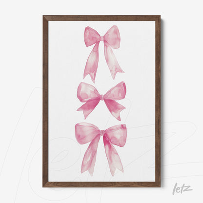 framed wall art featuring watercolor illustration of three pink bows with dark wood frame