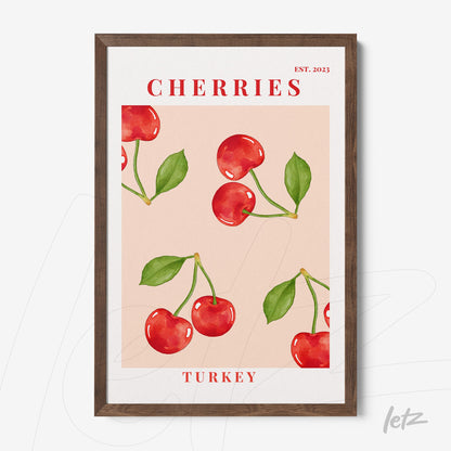 framed wall art featuring bright red cherries on a pink background with modern typography