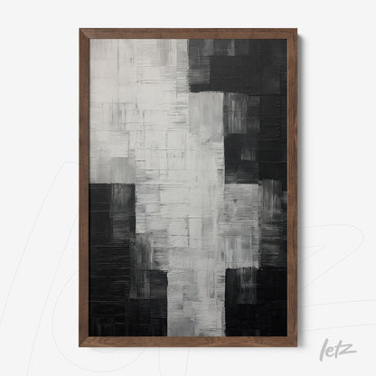 canvas art featuring abstract design in black, white, and gray with dark wood frame