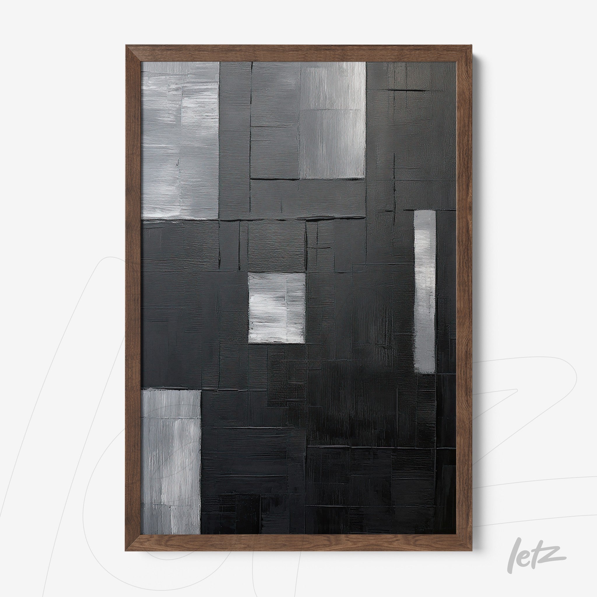 abstract wall art in black, gray, and white shades with dark wood frame
