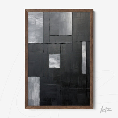 abstract wall art in black, gray, and white shades with dark wood frame