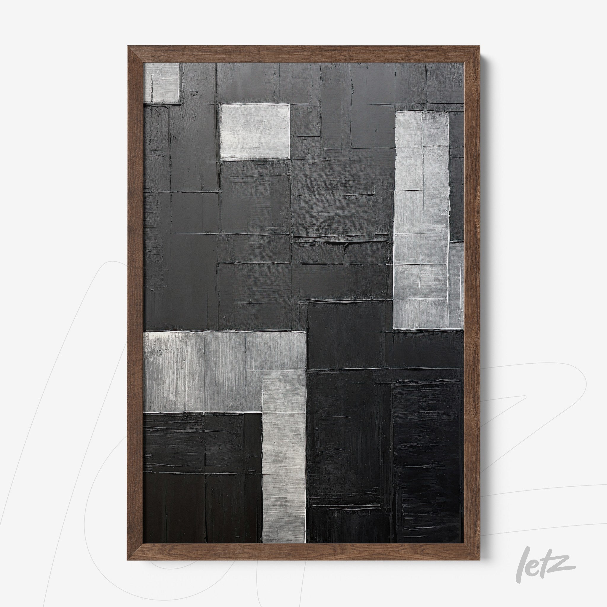 abstract wall art in black and gray tones framed in light wood
