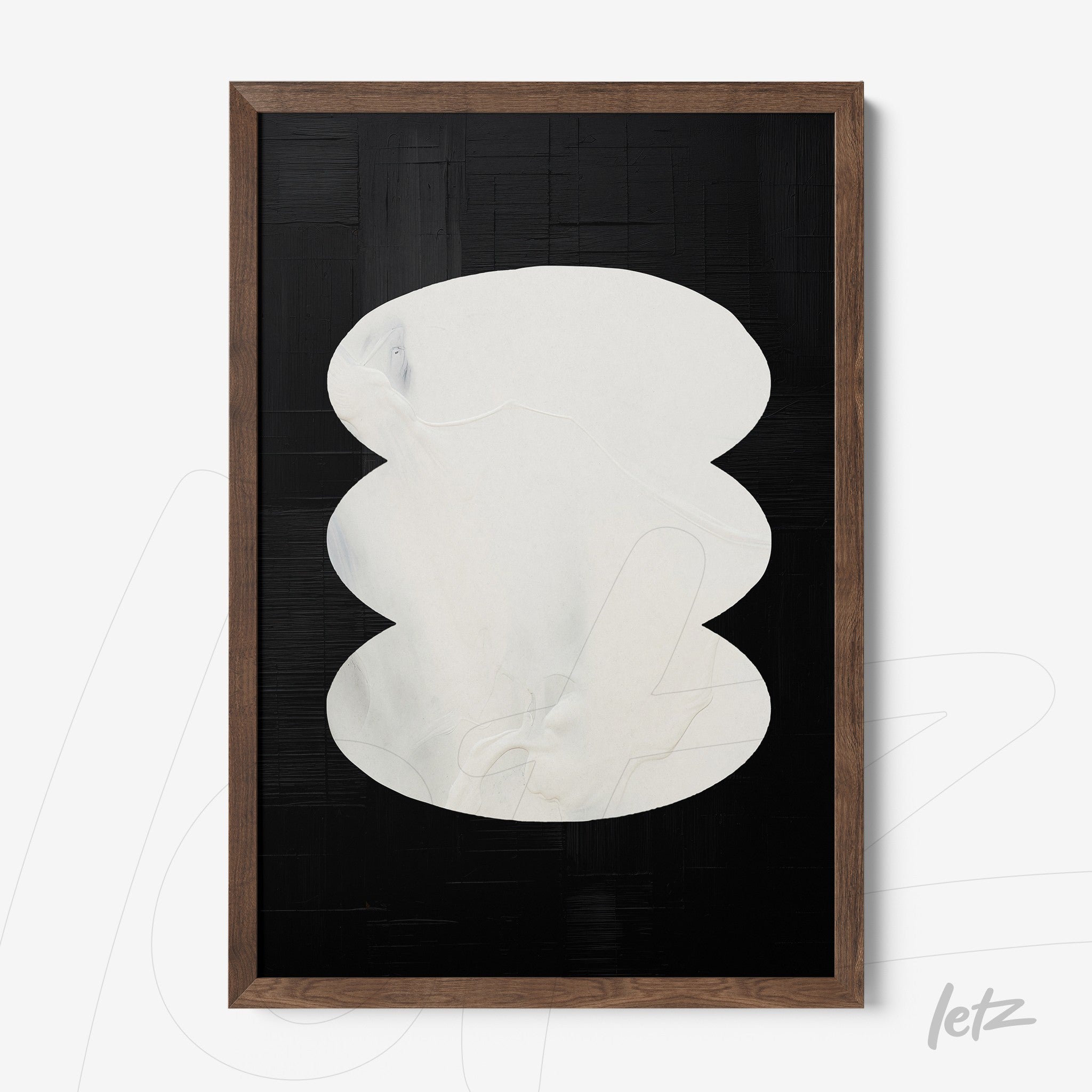 abstract wall art featuring white ovals on black background with dark wood frame