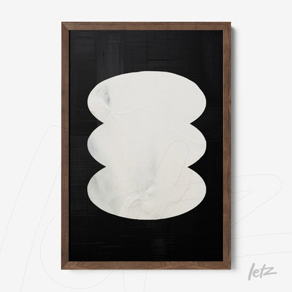 abstract wall art featuring white ovals on black background with dark wood frame