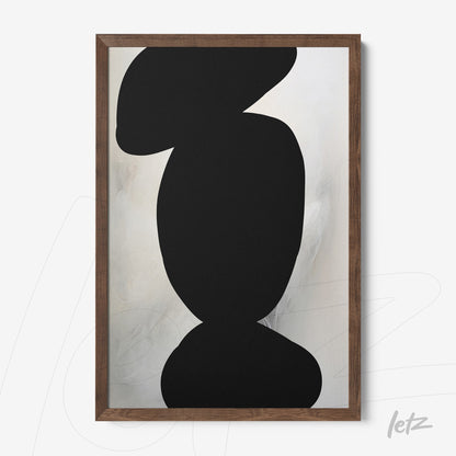 framed abstract art featuring light background and organic black shapes in dark wood frame