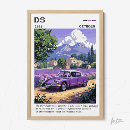 framed digital art of a 1969 Citroën DS car in pixel art style with light wooden frame and rural landscape background featuring mountains in the distance
