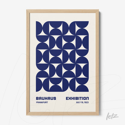 framed wall art with navy blue geometric design in Bauhaus style, set in a light wood frame