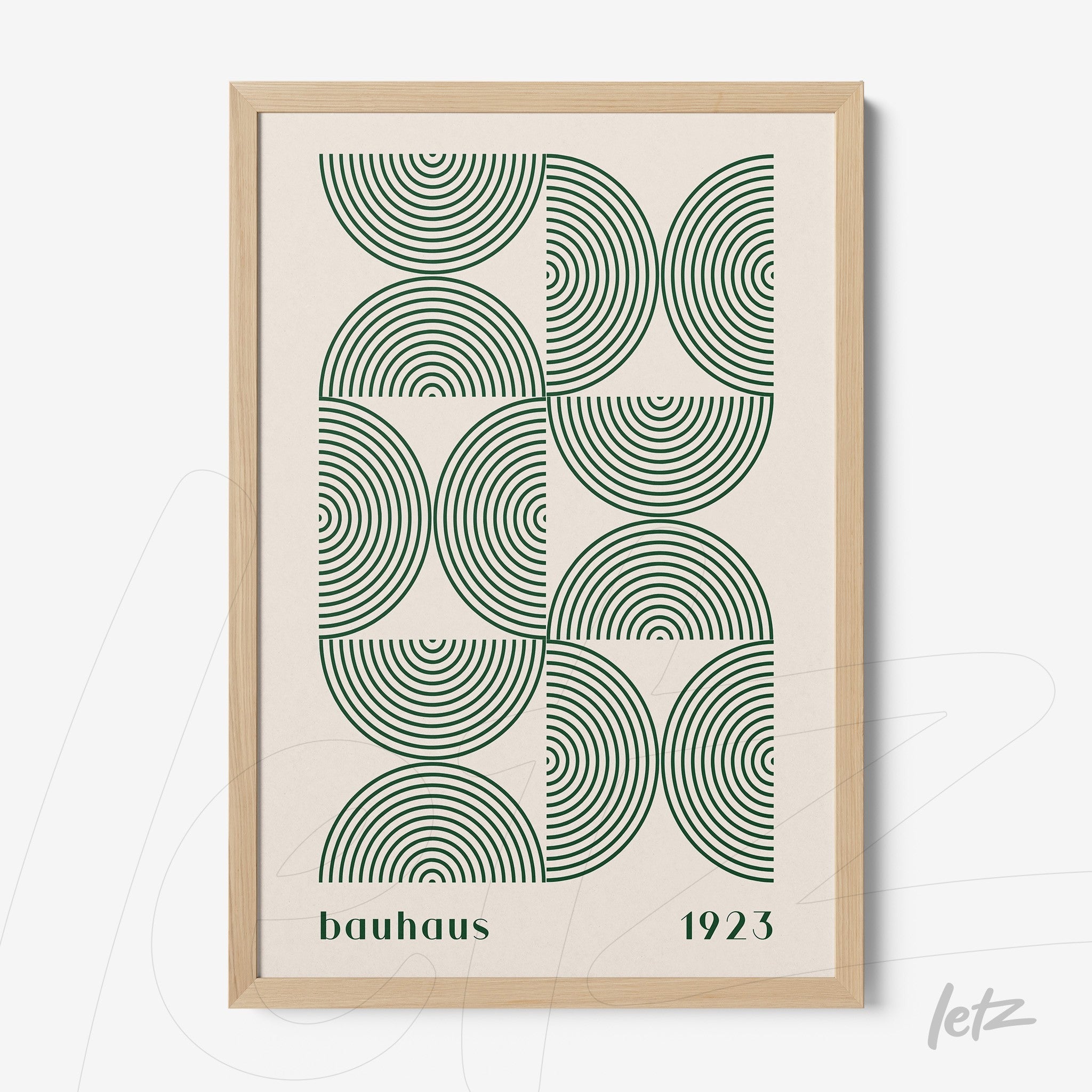 framed wall art featuring green concentric circles in bauhaus style with light wood frame