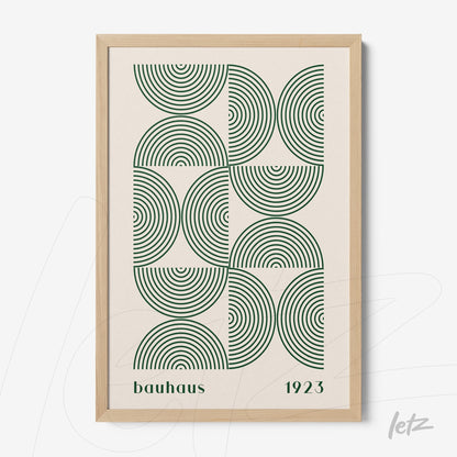 framed wall art featuring green concentric circles in bauhaus style with light wood frame