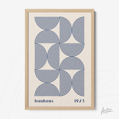 poster with geometric art in blue featuring concentric circles in a light wood frame