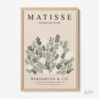 framed art featuring stylized leaves in light wood frame against a neutral background