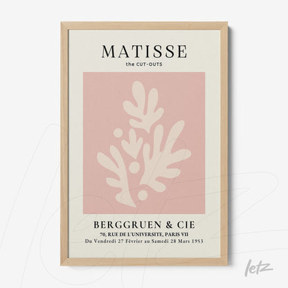 framed modern art inspired by Matisse featuring pink background with white shapes in light wood frame