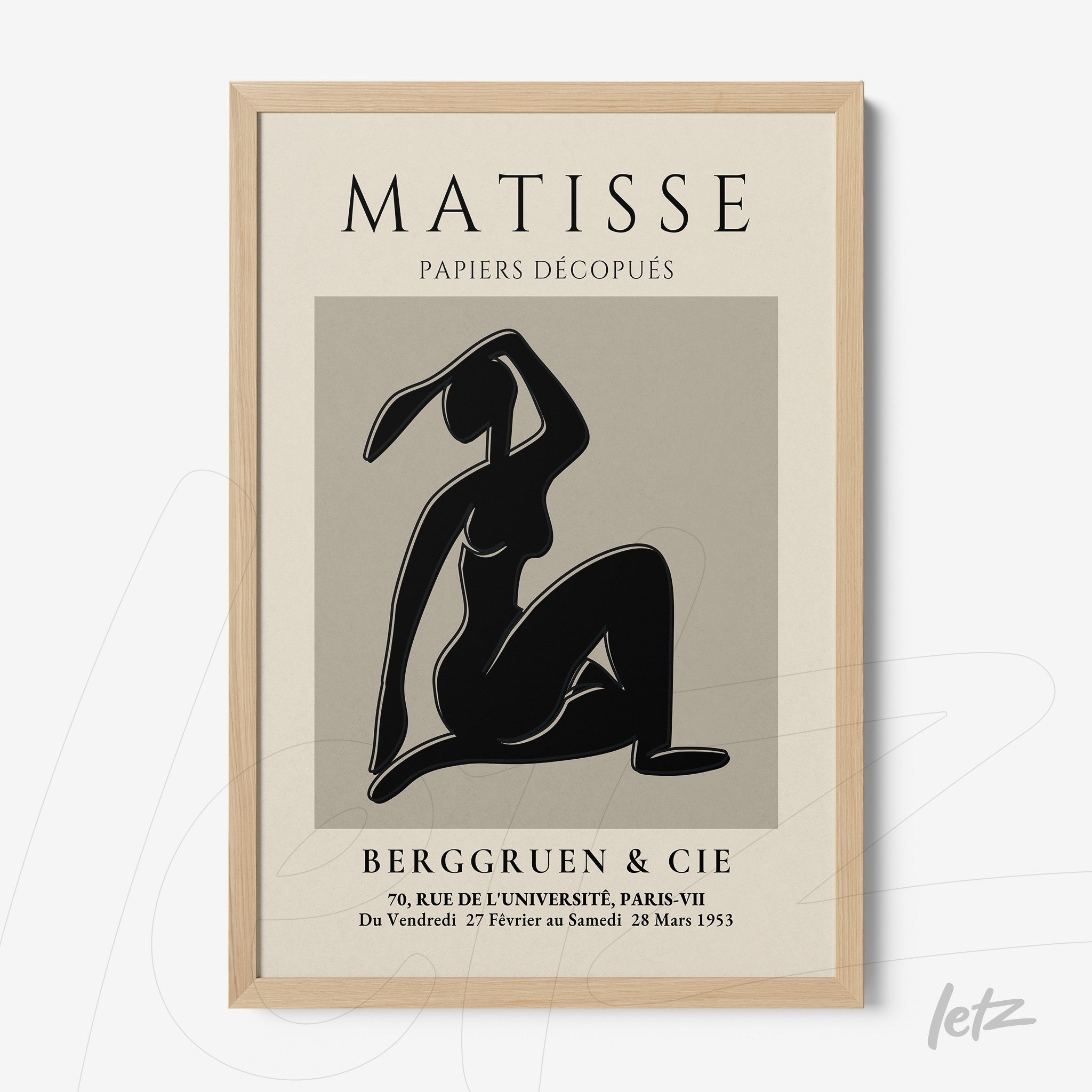 framed wall art featuring a stylized female figure in black on a gray background with light wood frame