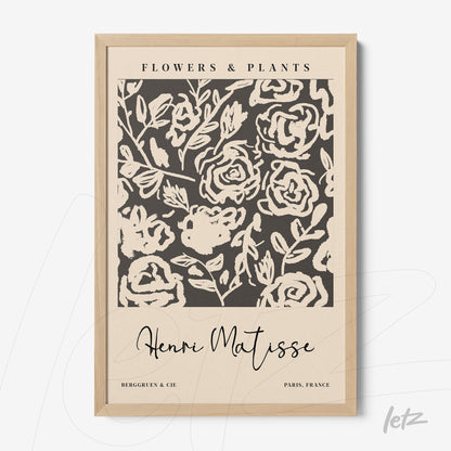 framed art print featuring floral design on dark background with light wood frame and artist signatures