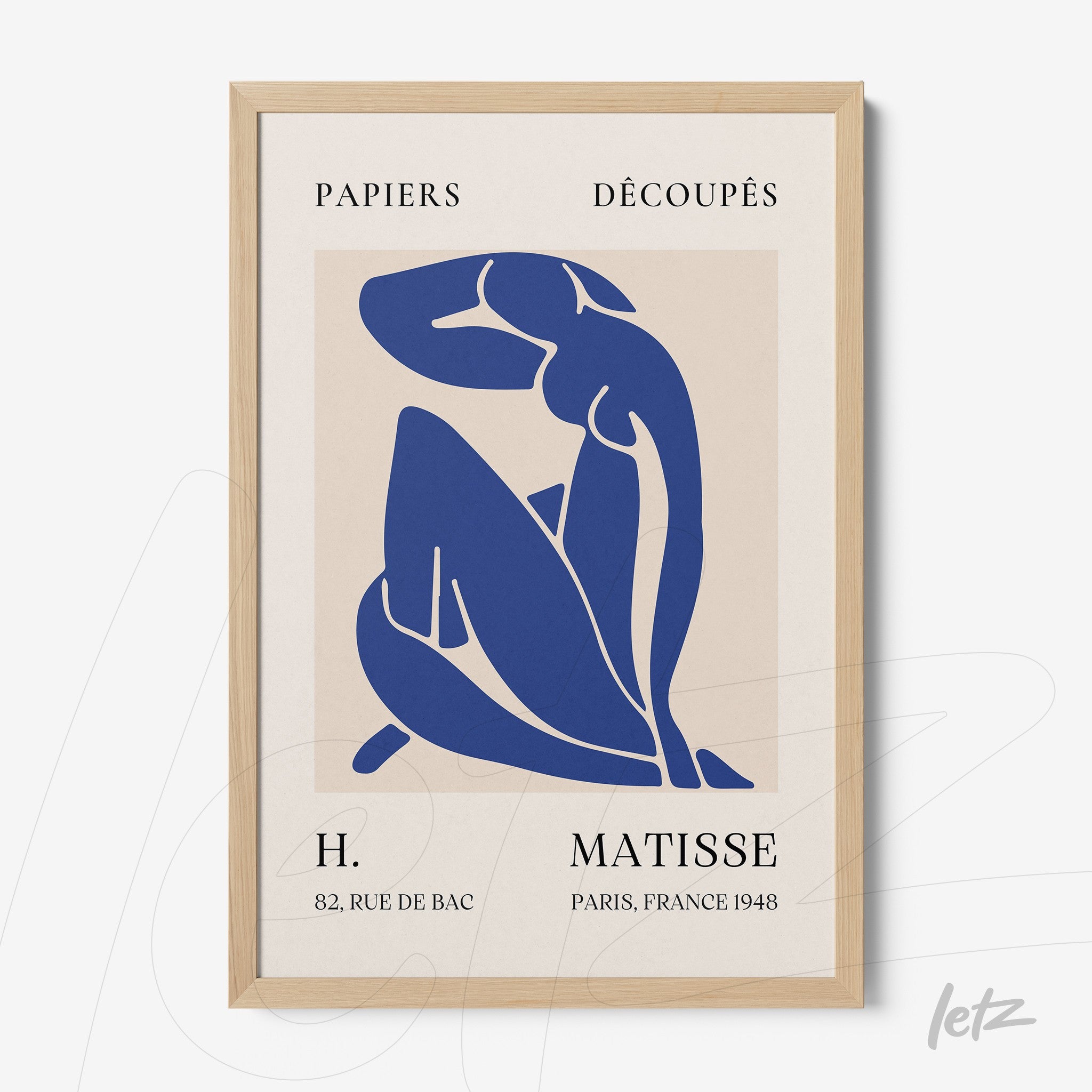 decorative wall art featuring modernist blue cut-out of a seated female figure with a light wood frame