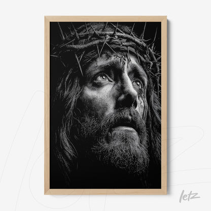 framed black and white portrait of a religious figure wearing a crown of thorns with light wood frame