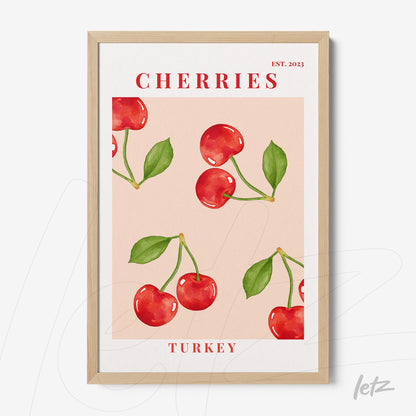 framed artwork featuring cherries on a light pink background with a light wood frame