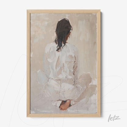 modern artwork of a woman sitting with her back to the viewer in a light wood frame