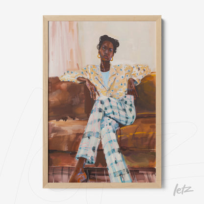 framed artwork depicting a seated Black woman in a floral blazer and plaid trousers on a sofa with a light wood frame