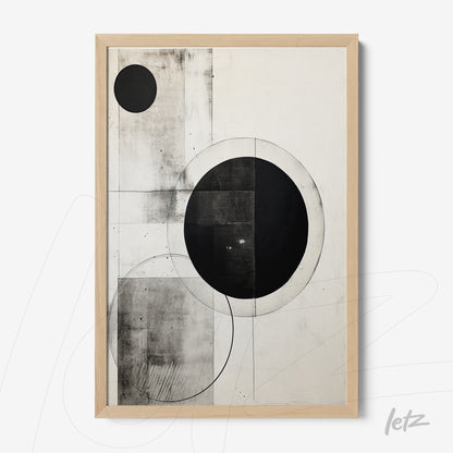framed abstract art in black and white featuring circles and geometric shapes on light background with light wooden frame
