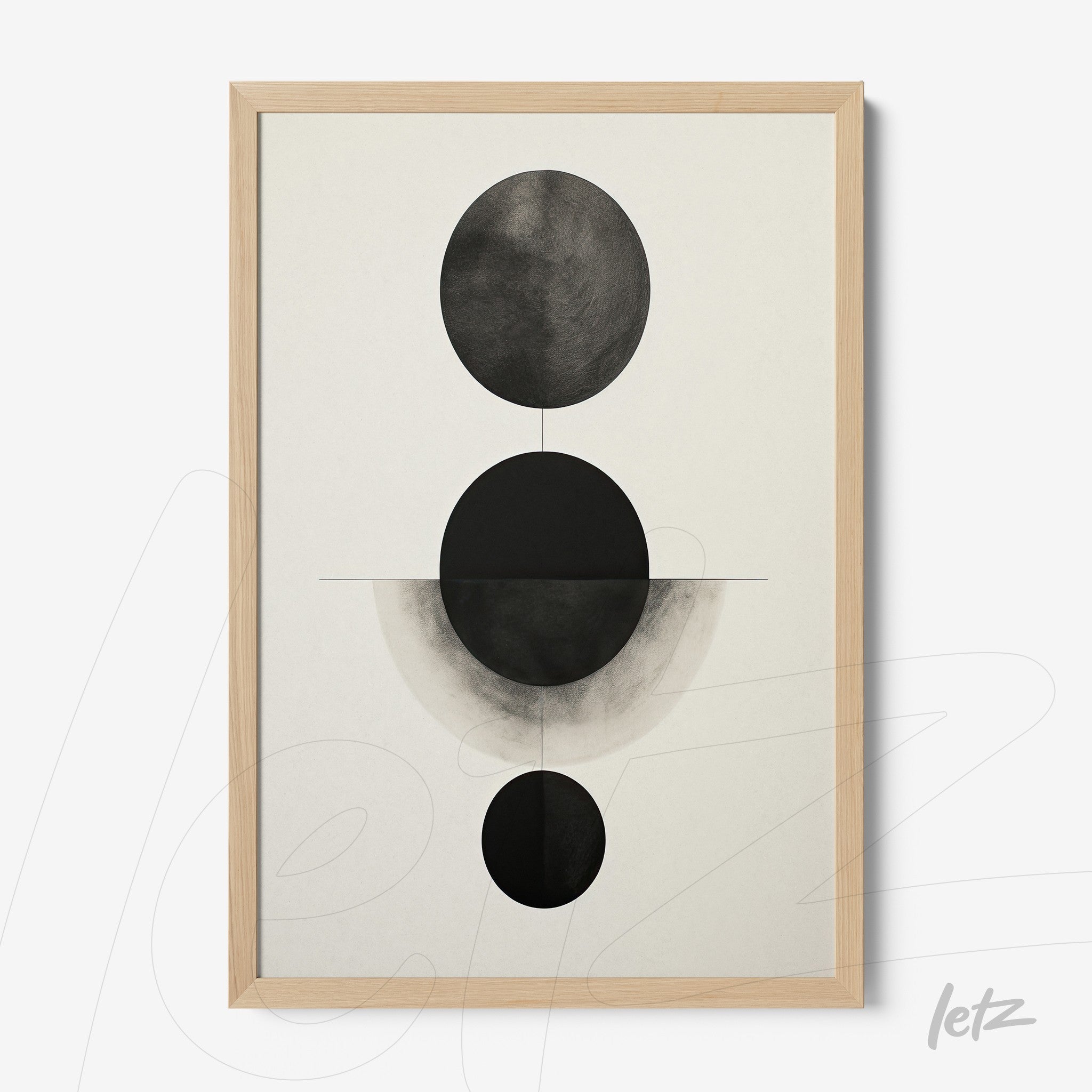 framed geometric wall art in black and white featuring circles on a light background with a light wood frame