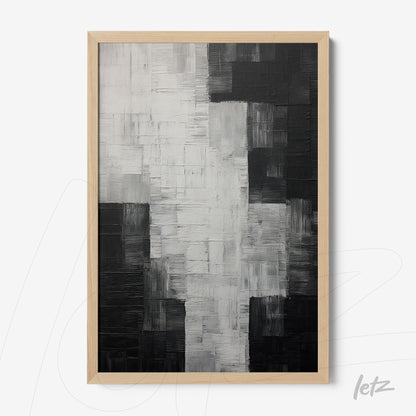 abstract black and white artwork with textured relief in light wood frame