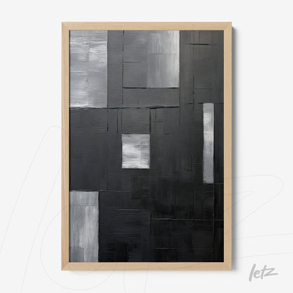 abstract artwork in shades of black and gray featuring varied textures in light wood frame