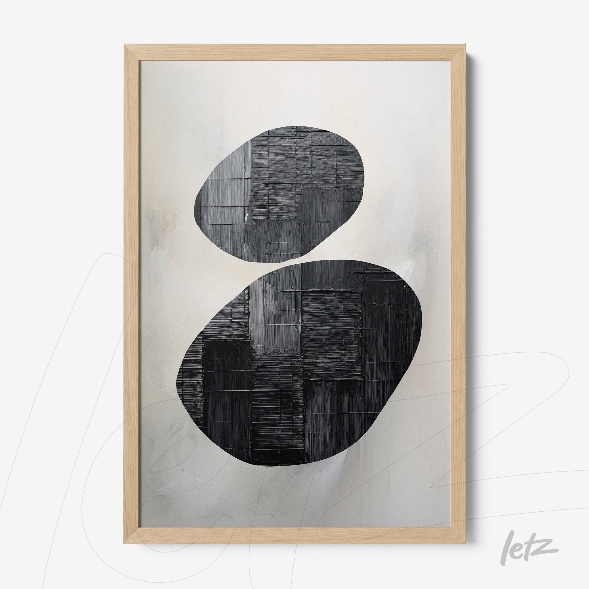 abstract art piece in black and white framed with light wood
