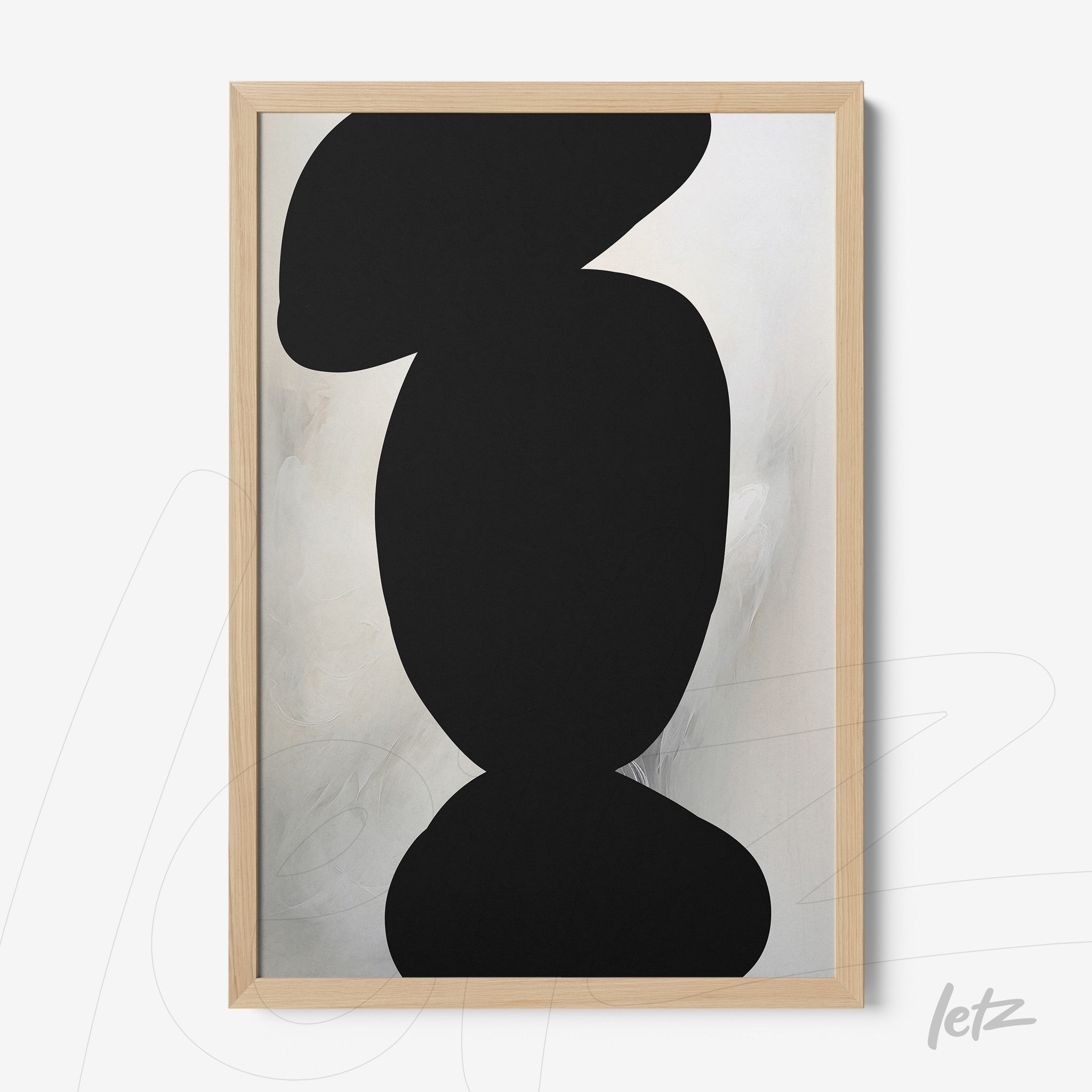 framed abstract wall art with light background and black shapes in light wood frame