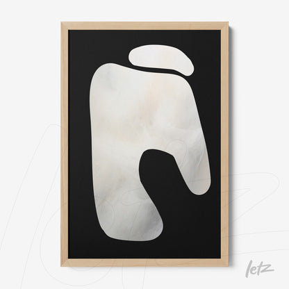 abstract wall art with white shape on black background in light wood frame