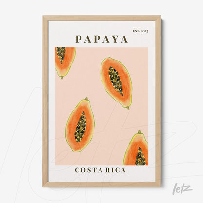 framed wall art featuring illustrations of papaya slices on a pink background with light wooden frame