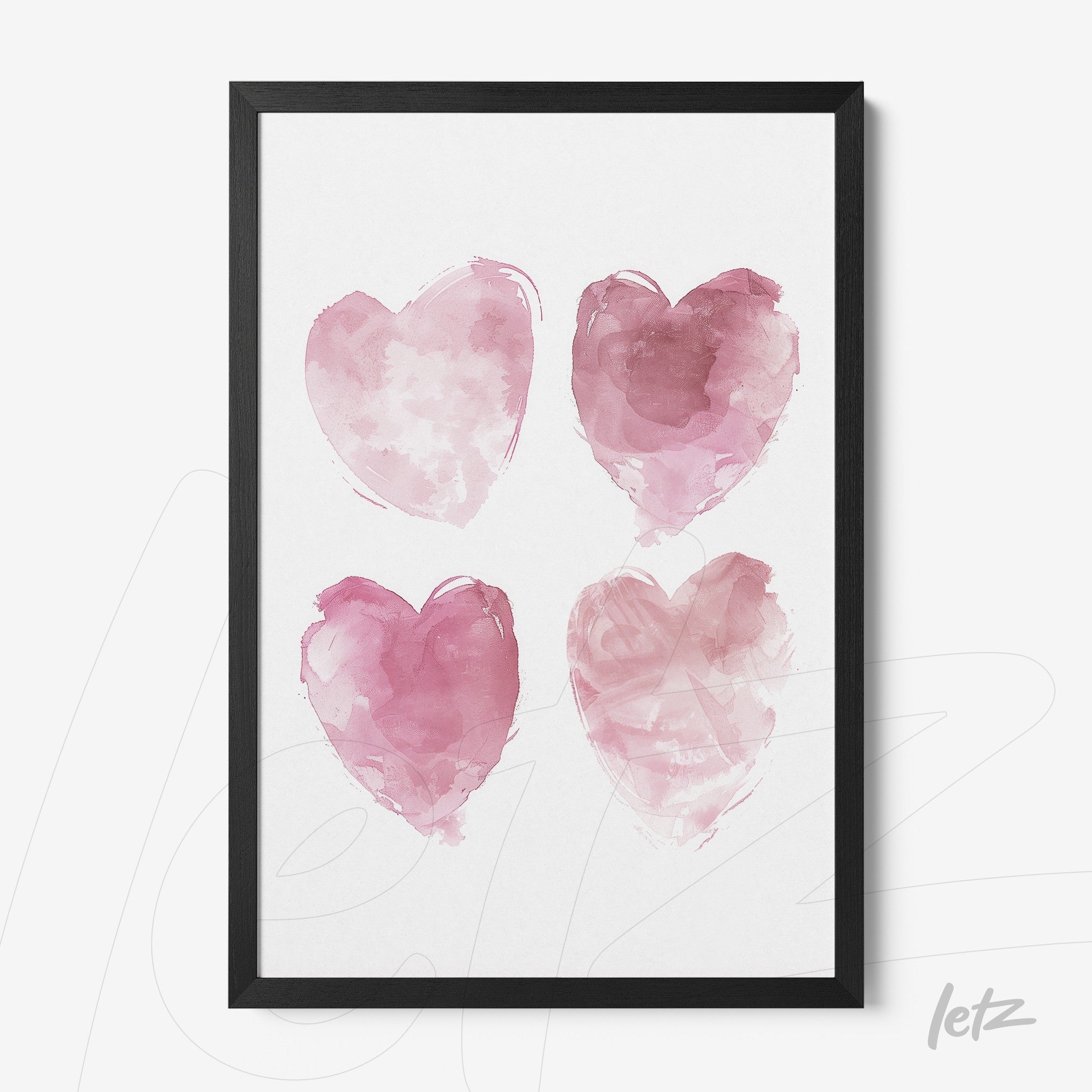 framed wall art featuring four pink watercolor hearts with a black frame