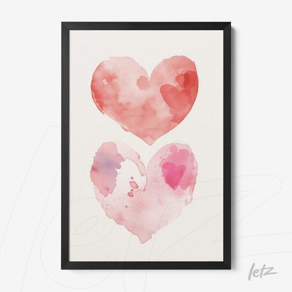 framed wall art featuring watercolor hearts in shades of pink and red with a black frame