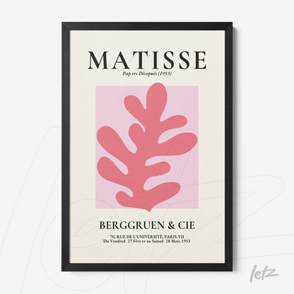 framed wall art in the style of Matisse featuring a pink plant shape on a light pink background with a black frame