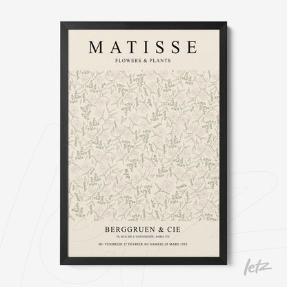 framed vintage style wall art featuring a light background with floral and leaf patterns in black frame