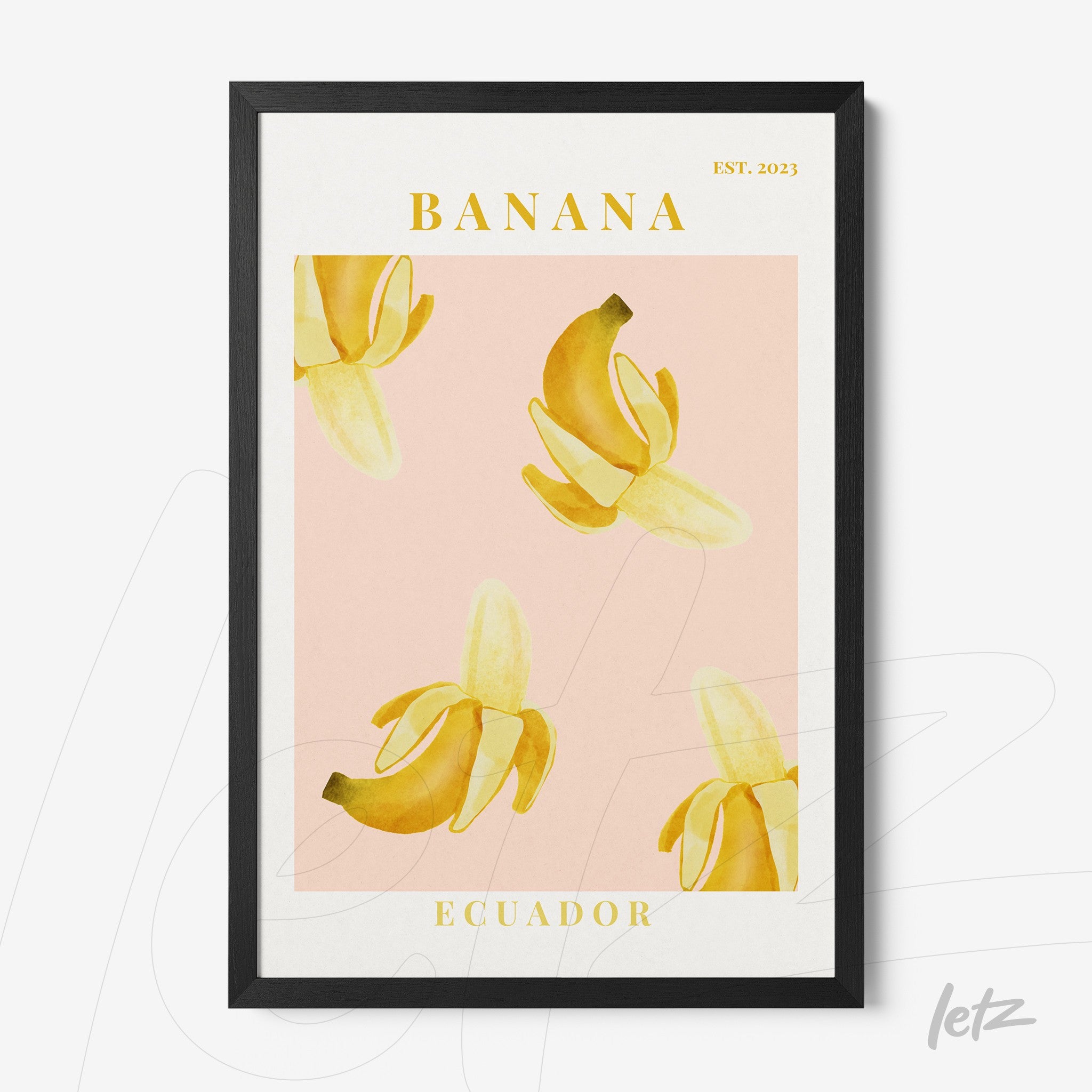 framed graphic art featuring bananas on a pink background with black frame