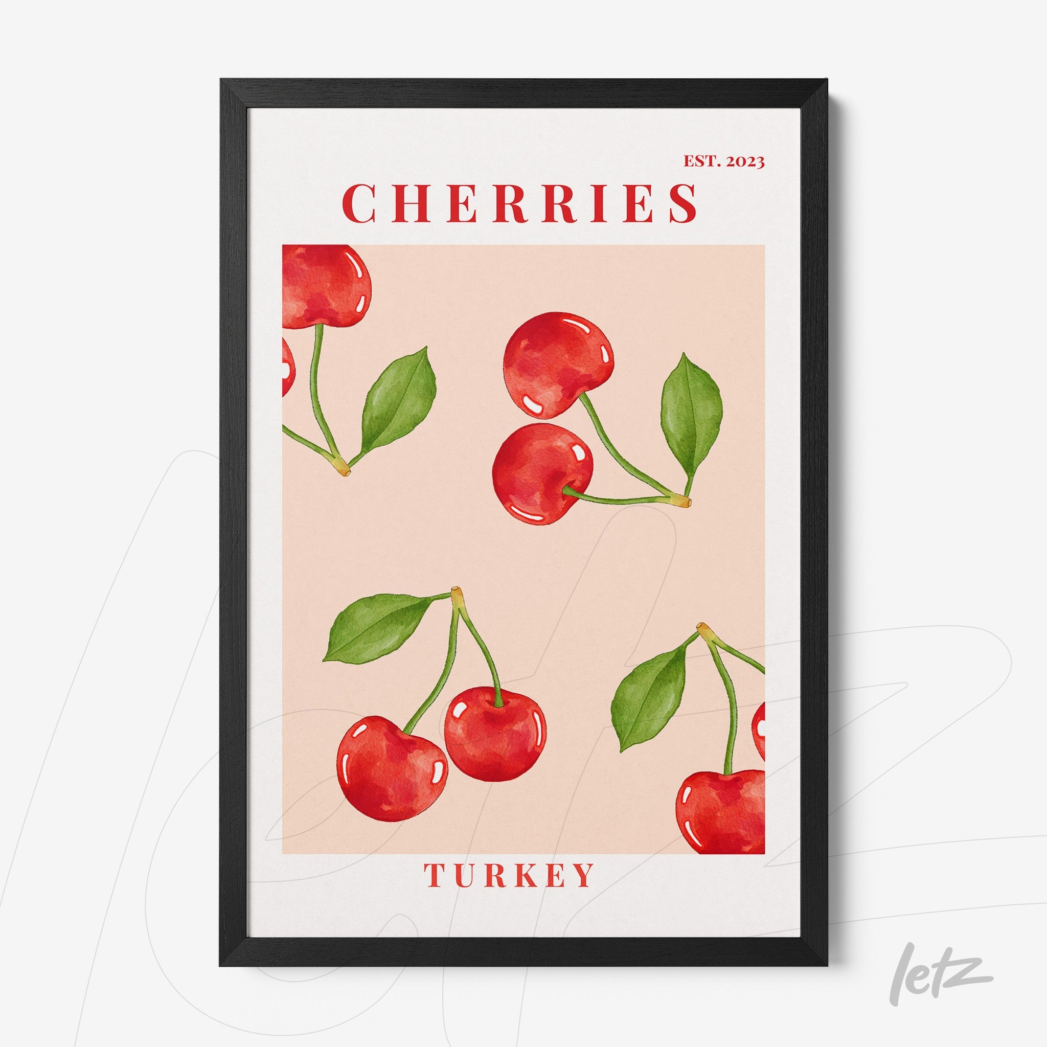 framed artwork featuring red cherries on a pink background with black frame