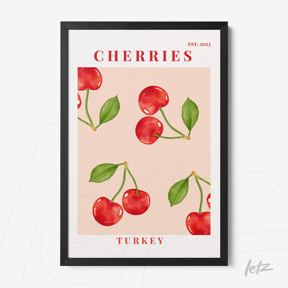 framed artwork featuring red cherries on a pink background with black frame