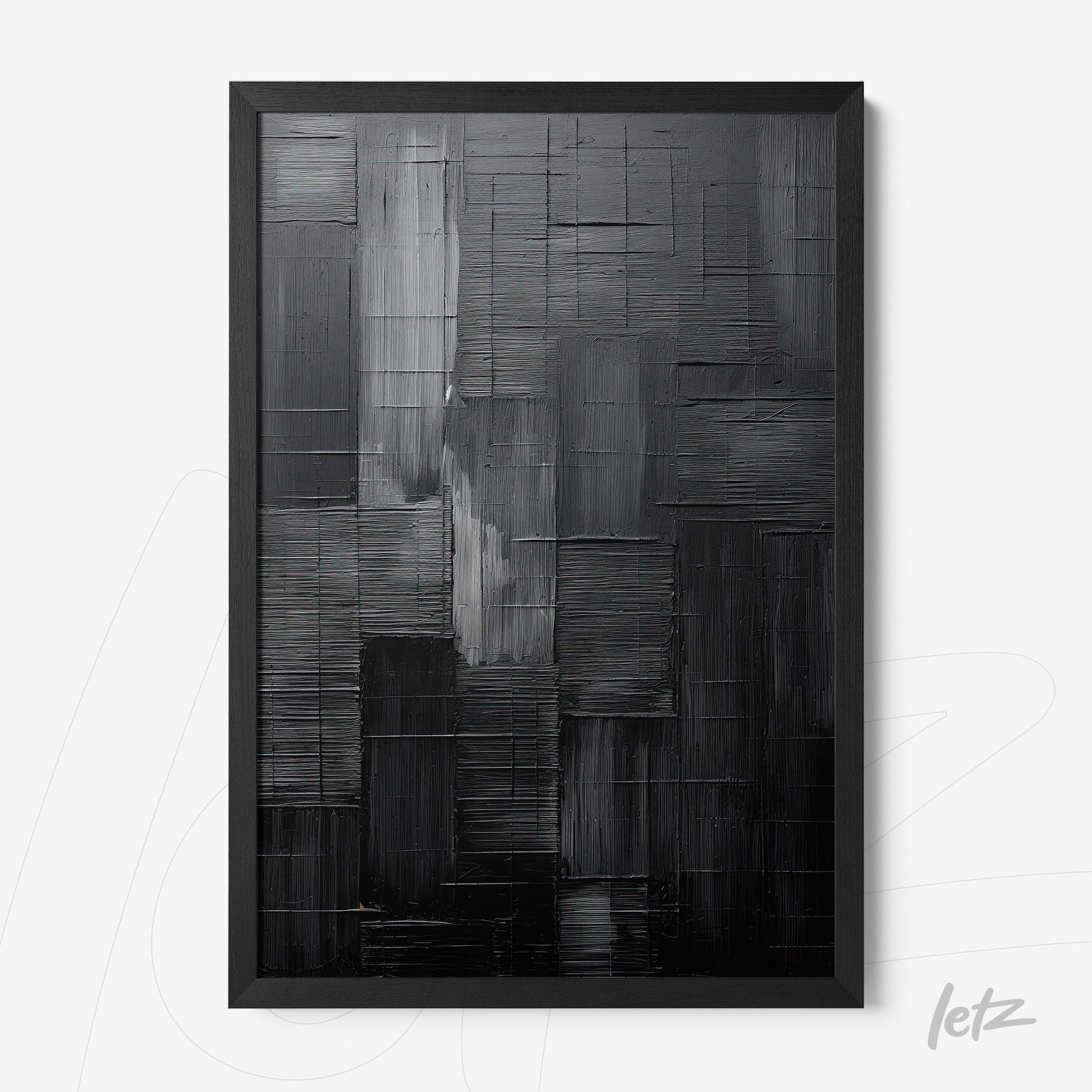 abstract wall art in shades of black and gray with a black frame
