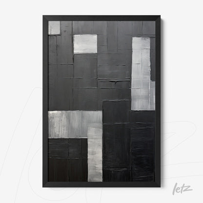 framed abstract artwork in shades of gray and black featuring distinct geometric shapes with varying textures
