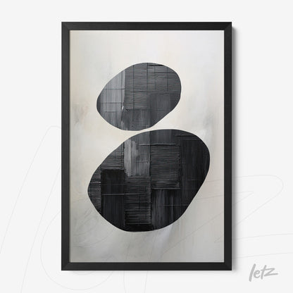 abstract wall art featuring black and gray oval shapes on a soft background