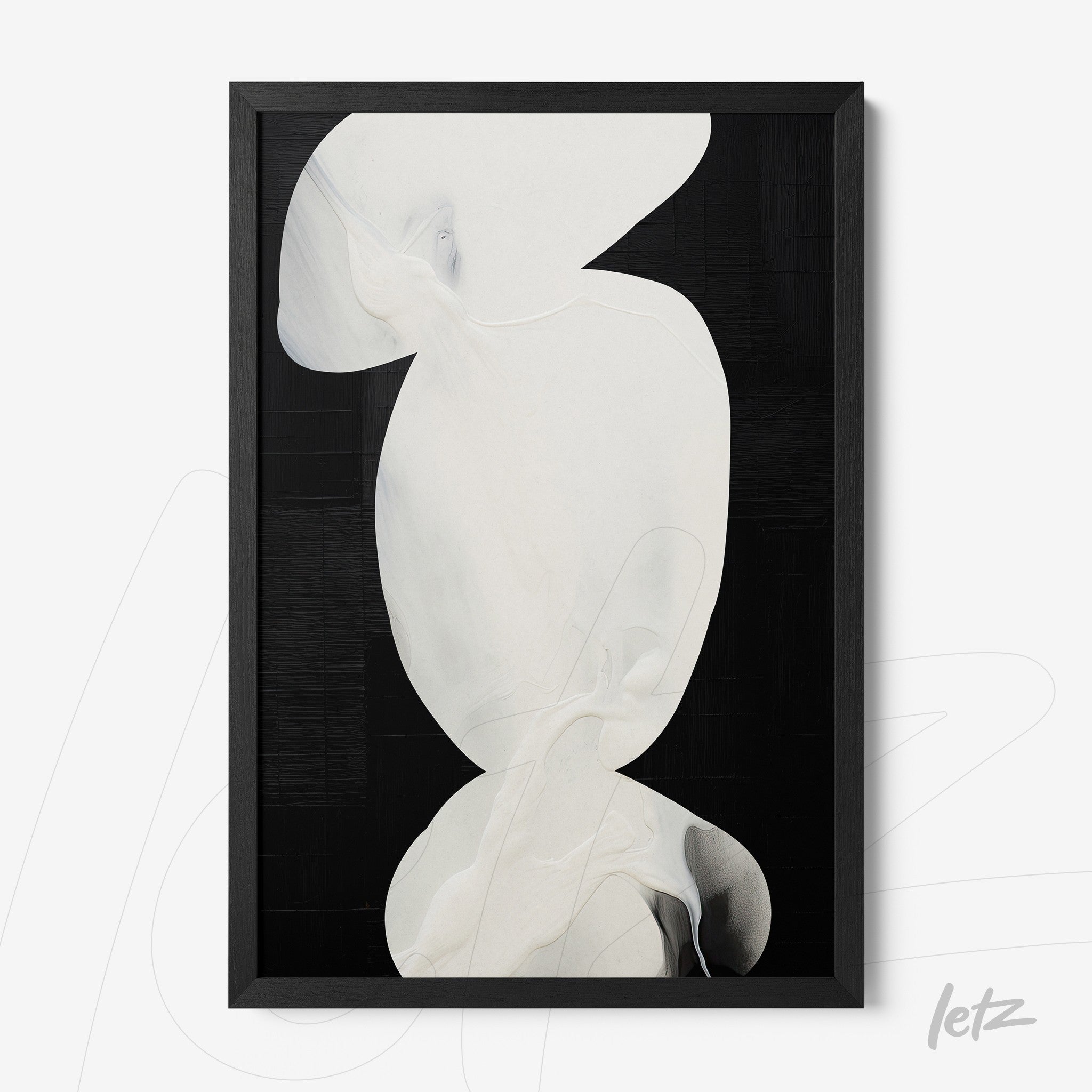 abstract wall art in black frame featuring white shapes on black background