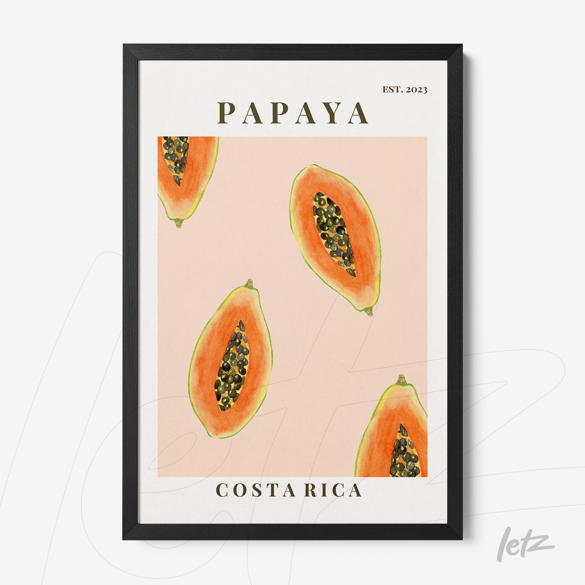 wall art featuring slices of papaya on pink background with black frame