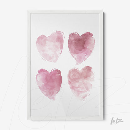 framed artwork featuring four pink watercolor hearts in white frame
