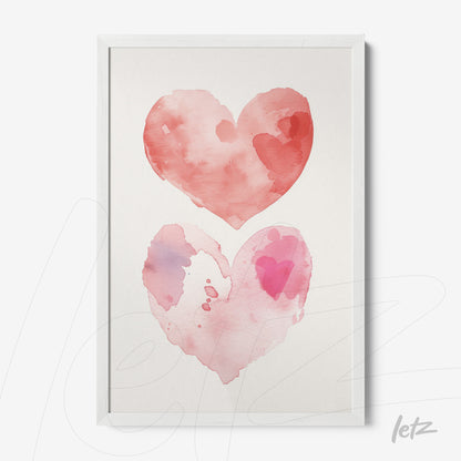 framed wall art featuring watercolor hearts in shades of red and pink with white frame